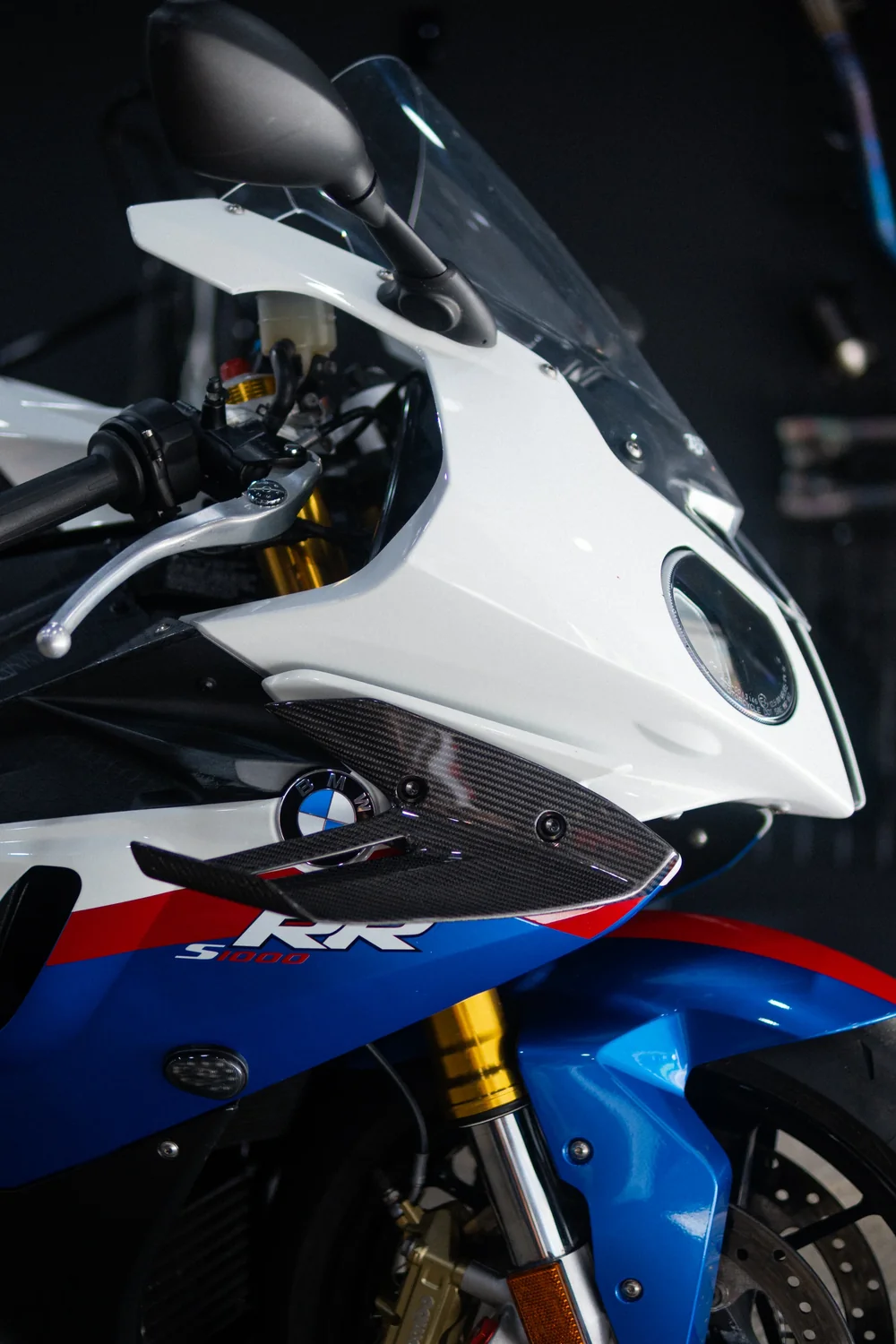 BMW S1000RR carbon aero winglet and BMW roundel badge, close-up