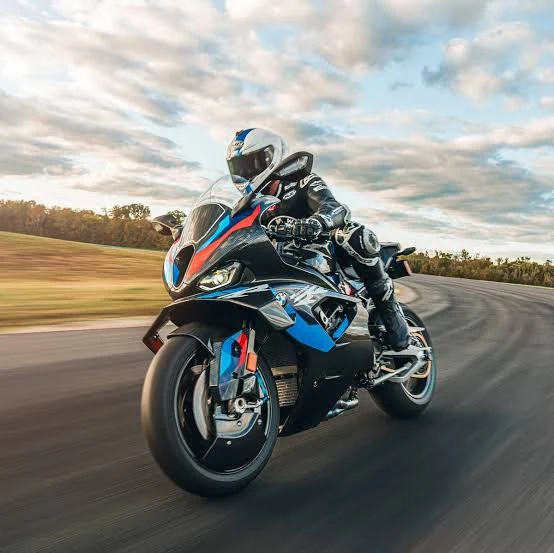 BMW M 1000 RR at speed, rider leaned into a corner on track